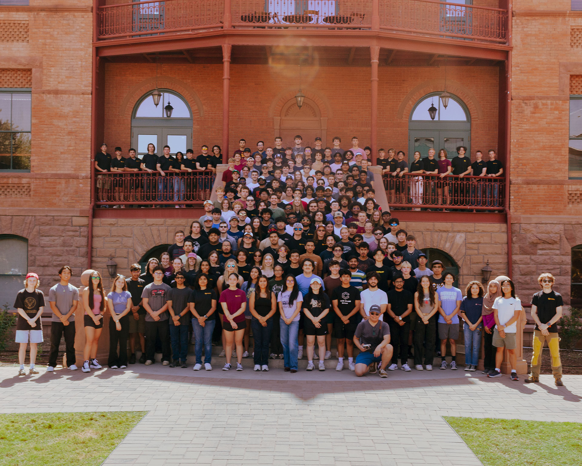 The leaders of the club pose on the Old Main front staircase for a photo.
