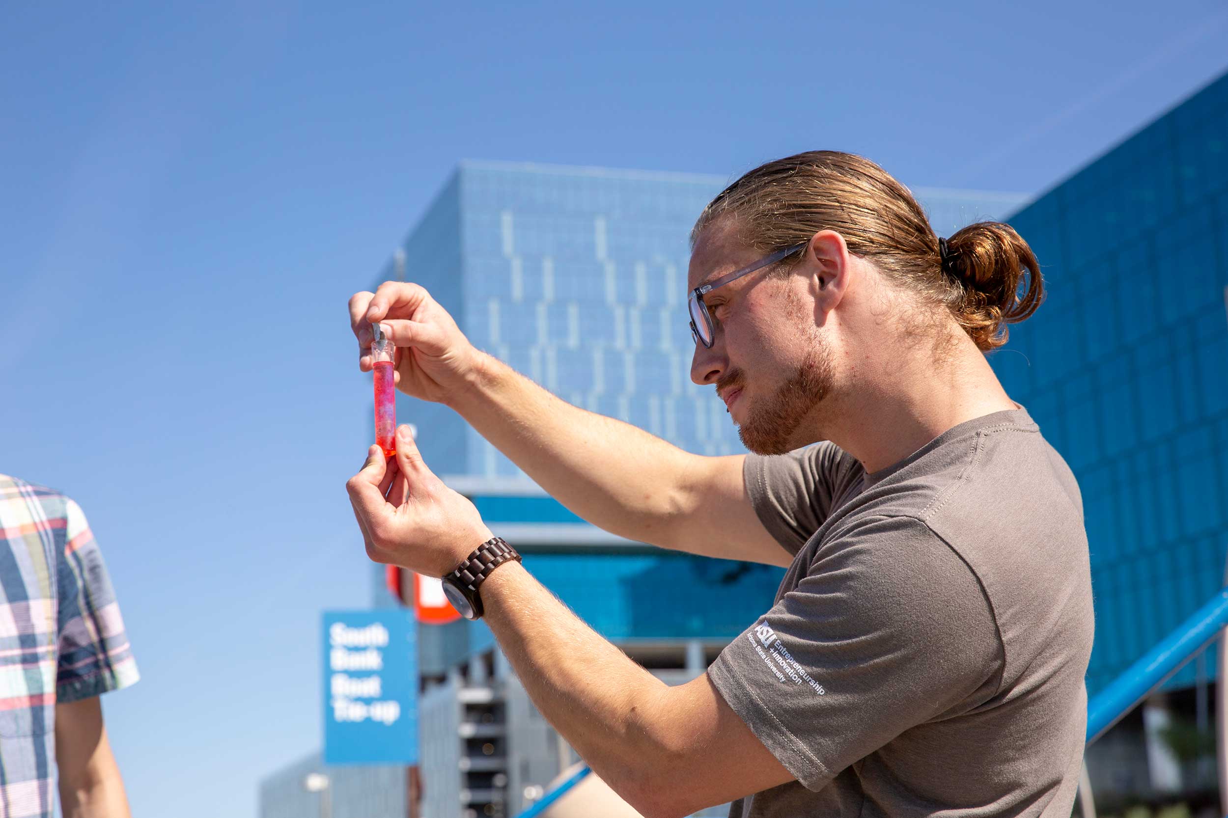 Daniel Hoop holds a water sample from Tempe Town Lake during his time as a student at ASU.