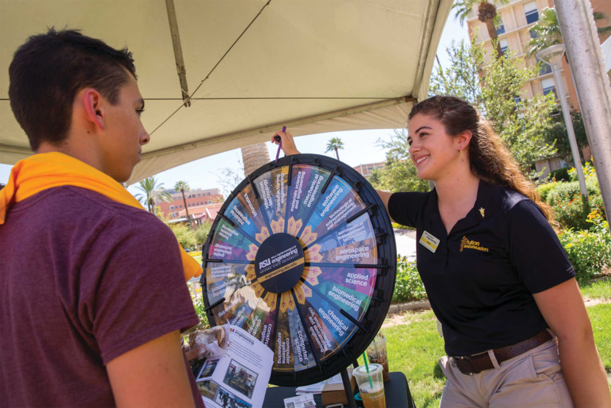 A Fulton Ambassador (right) shows the wheel of degrees to a student at the Fulton Schools Student Resource Fair
