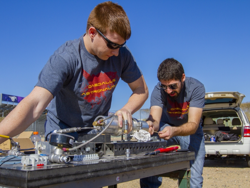 Members of Daedalus Astronautics, a Fulton student-run organization, work on a rocket engine.