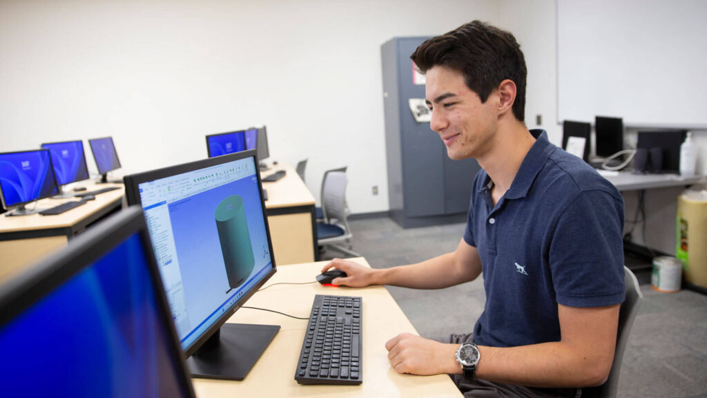 ASU Engineering student Tyler Norkus sits at a computer in a lab