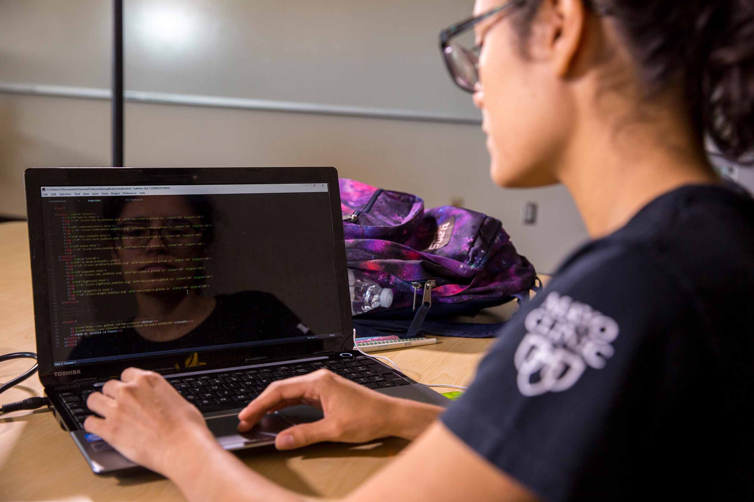 ASU student Cecilia Laplace coding on her computer.