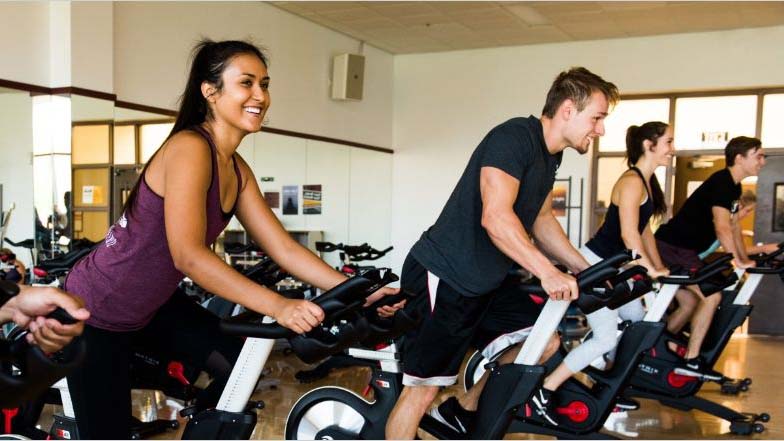 People riding exercise bikes at a Sun Devil Fitness Center