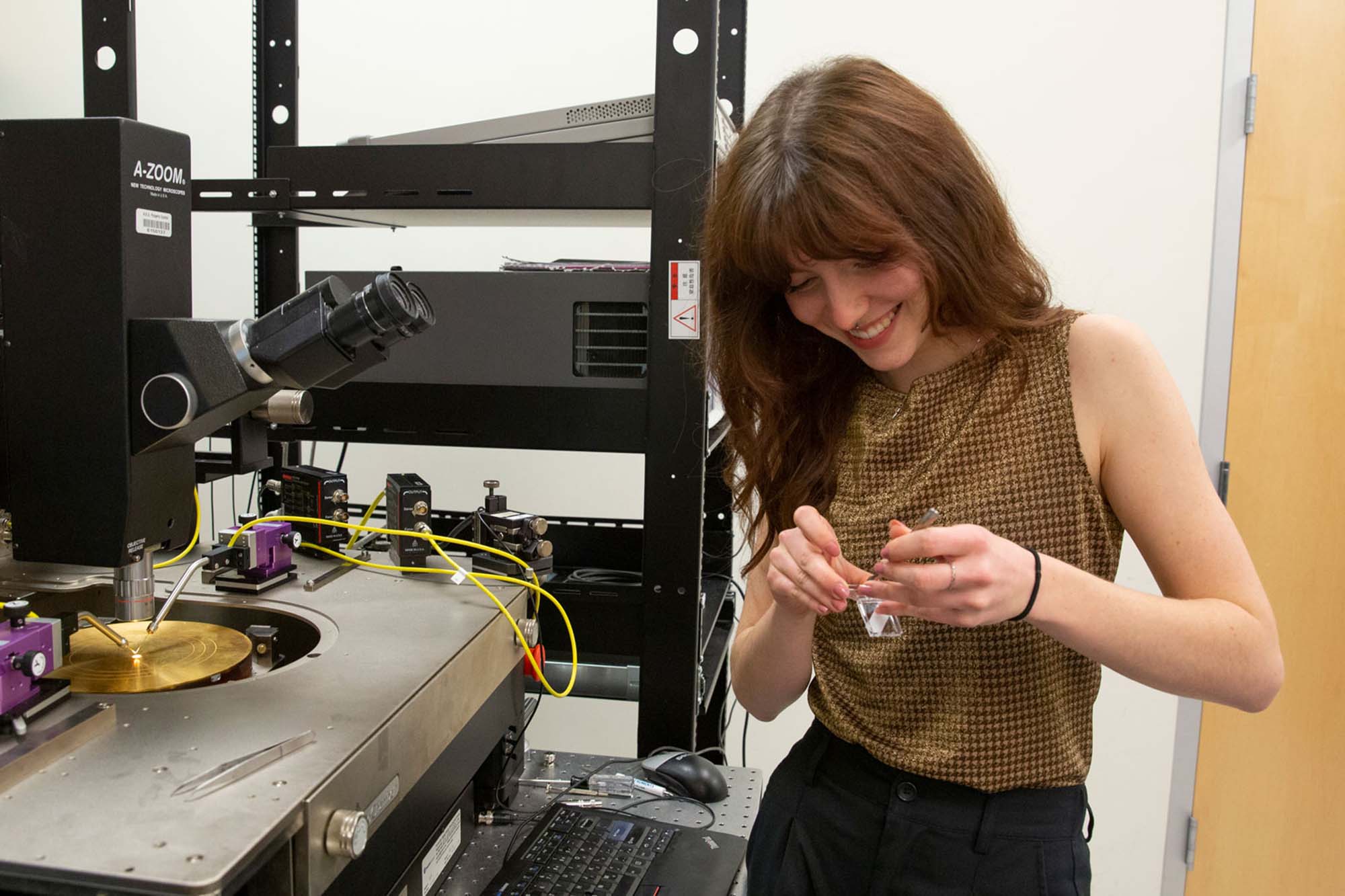 Hailey Warner, an electrical engineering student at Fulton Schools standing beside research equipment, working on a semiconductor-related project.