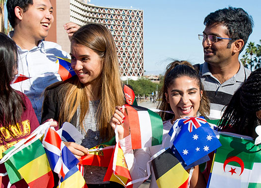 Young people with flags pose for a photo.
